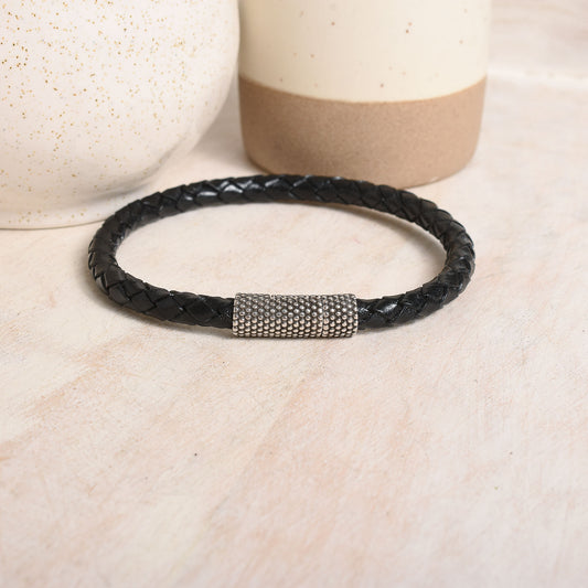 Round braided leather in black with a dotted silver clasp.
