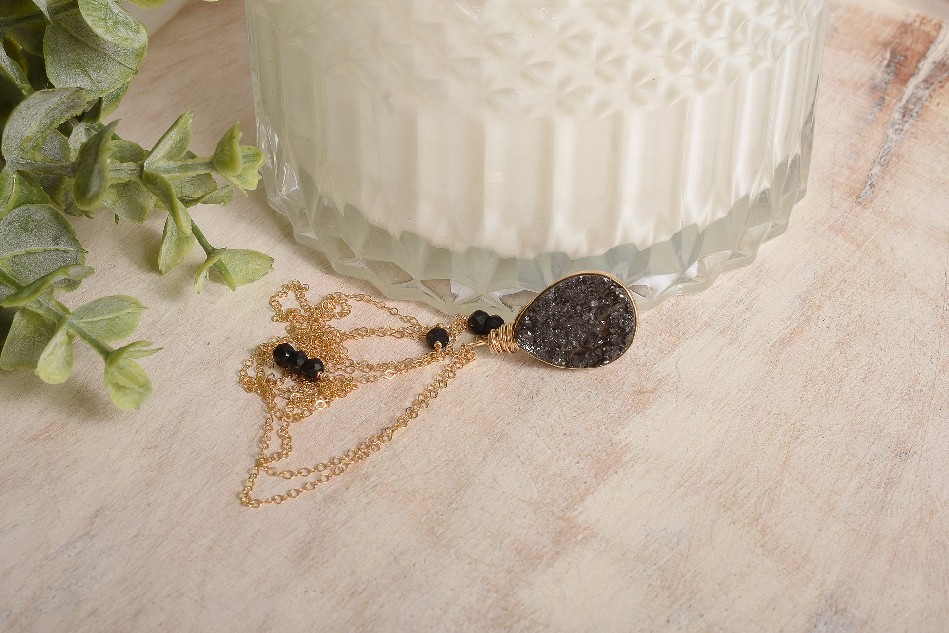 Dark stone pendant on gold chain