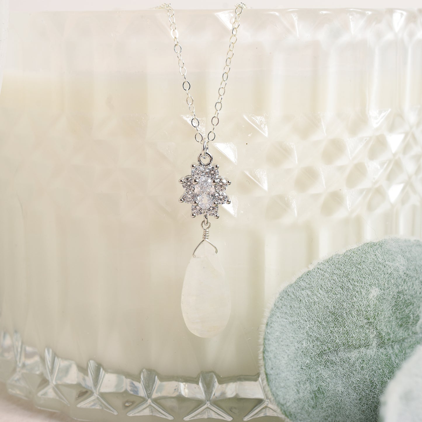 Moonstone and cubic zirconia pendant suspended from sterling silver chain 