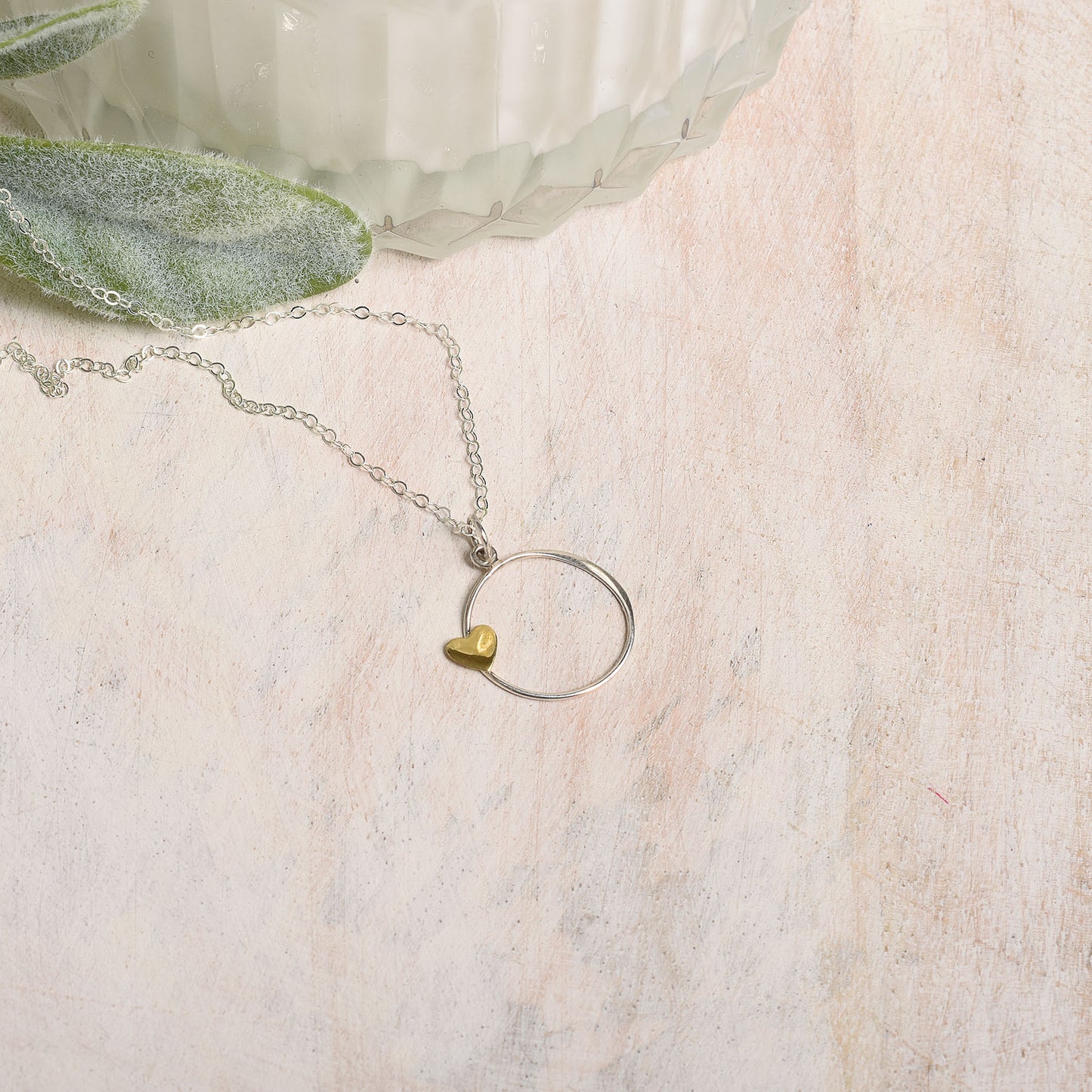 Necklace with a heart-shaped pendant on a textured surface
