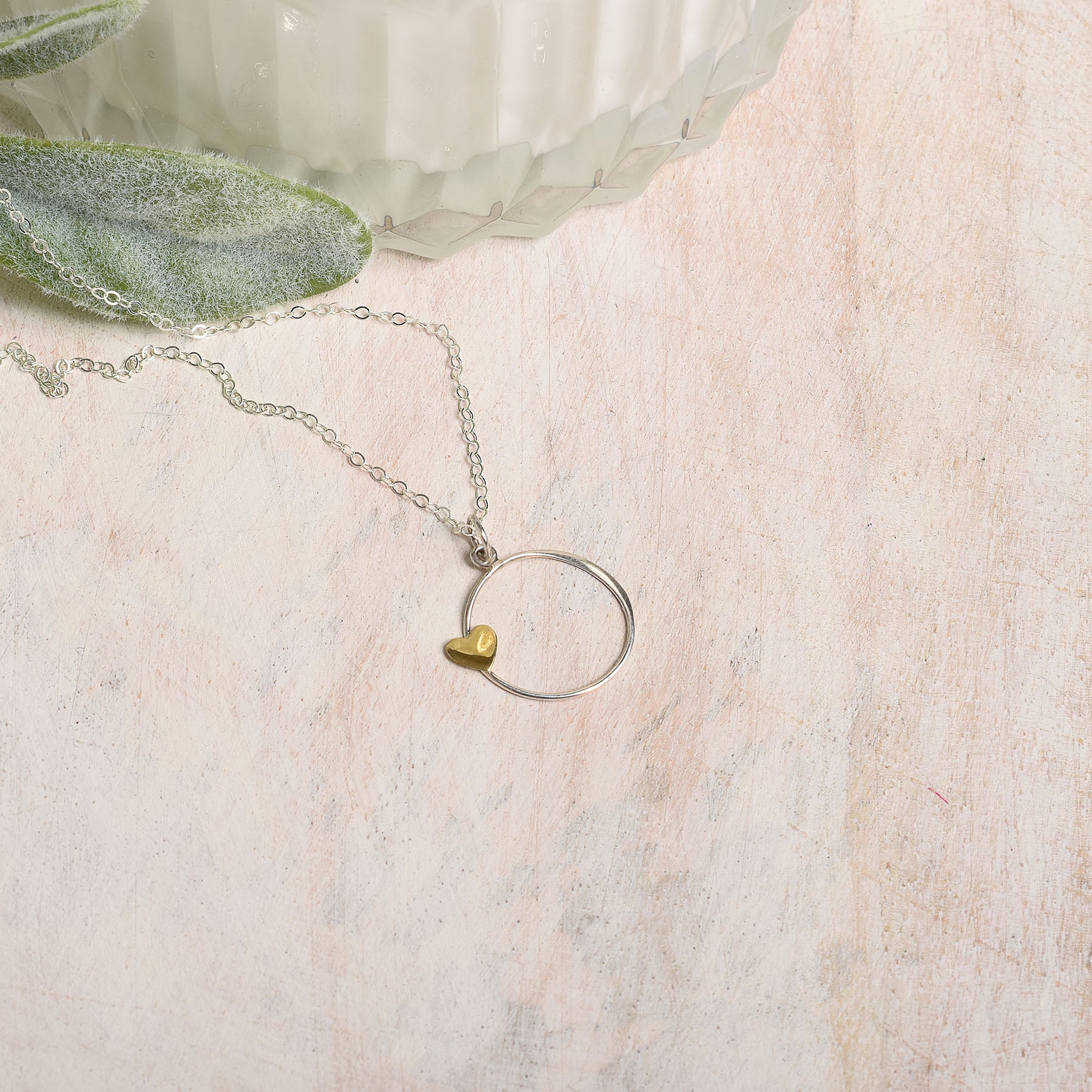 Necklace with a heart-shaped pendant on a textured surface