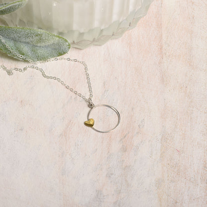 Necklace with a heart-shaped pendant on a textured surface