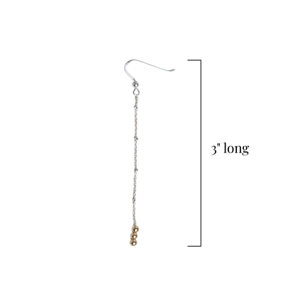 Silver chain earring with small round gold beads on a white background