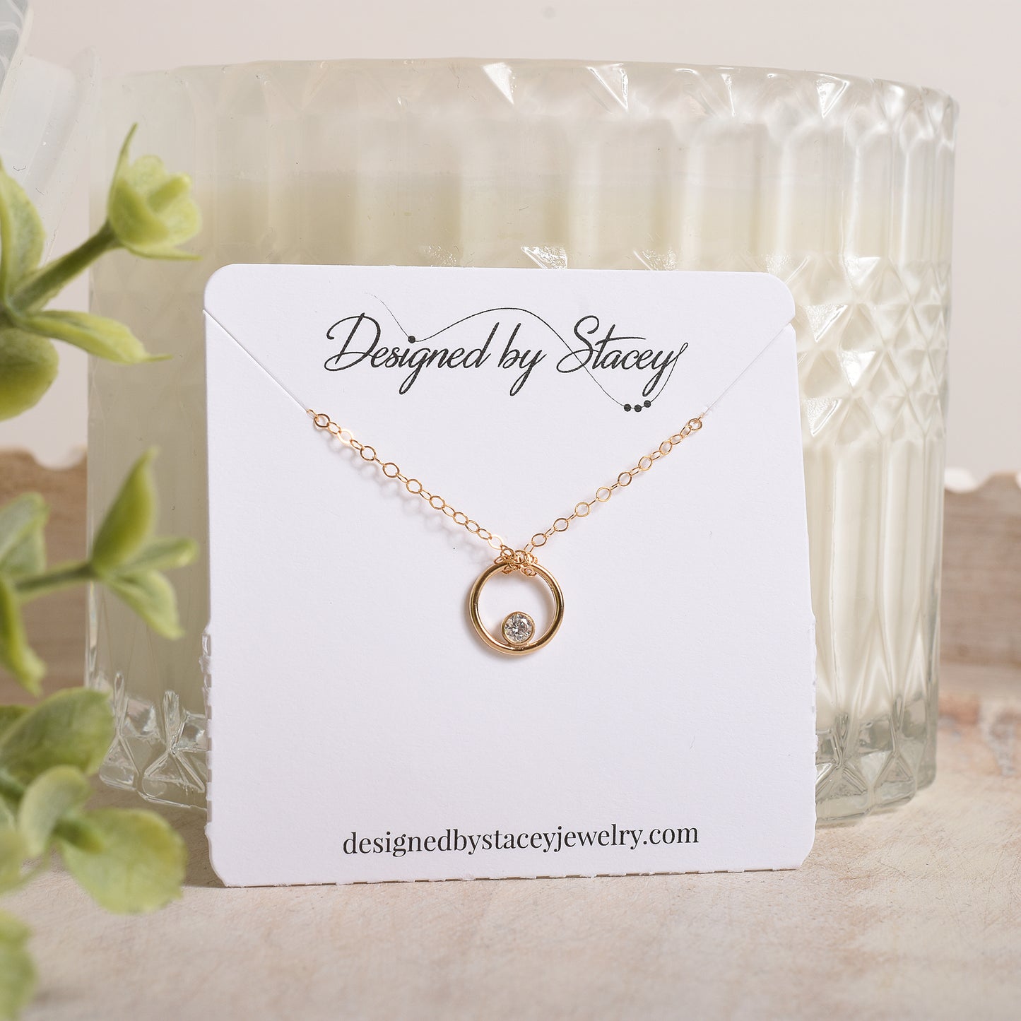 Gold necklace on a 'Designed by Stacey' necklace card 