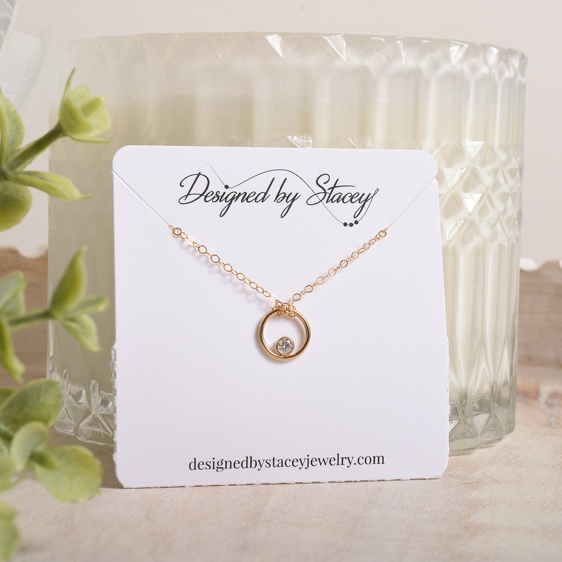 Gold necklace on a 'Designed by Stacey' necklace card 