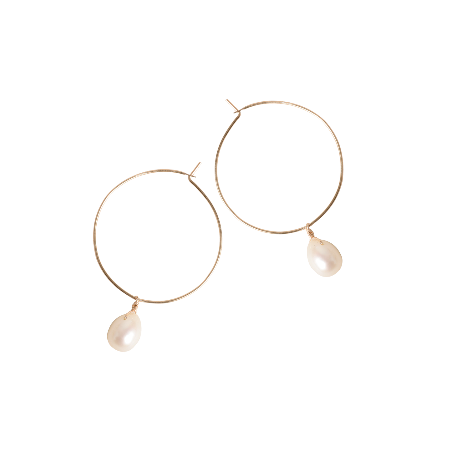 Gold hoop earrings with pearl drops on a white background