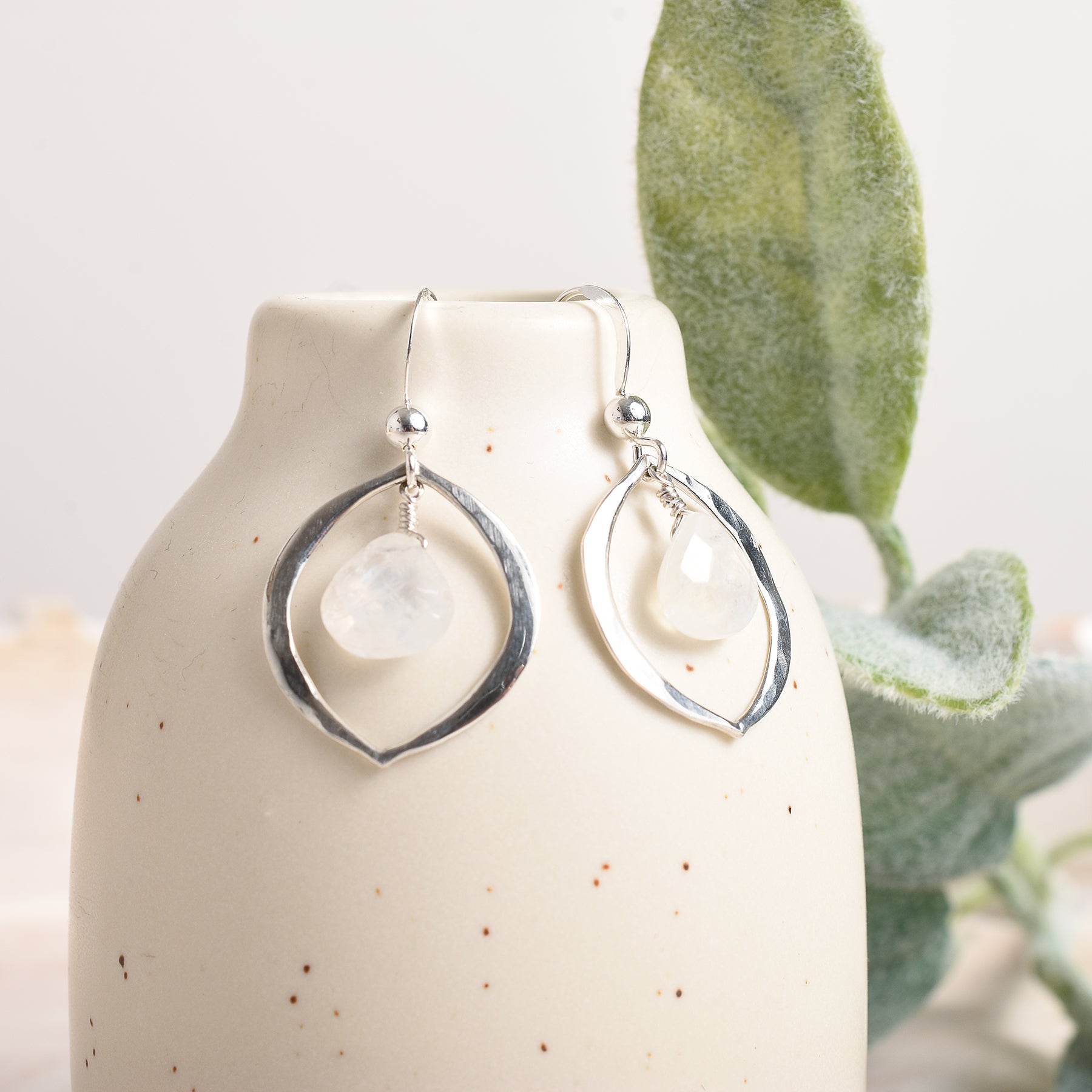 Silver earrings accented by rainbow moonstone