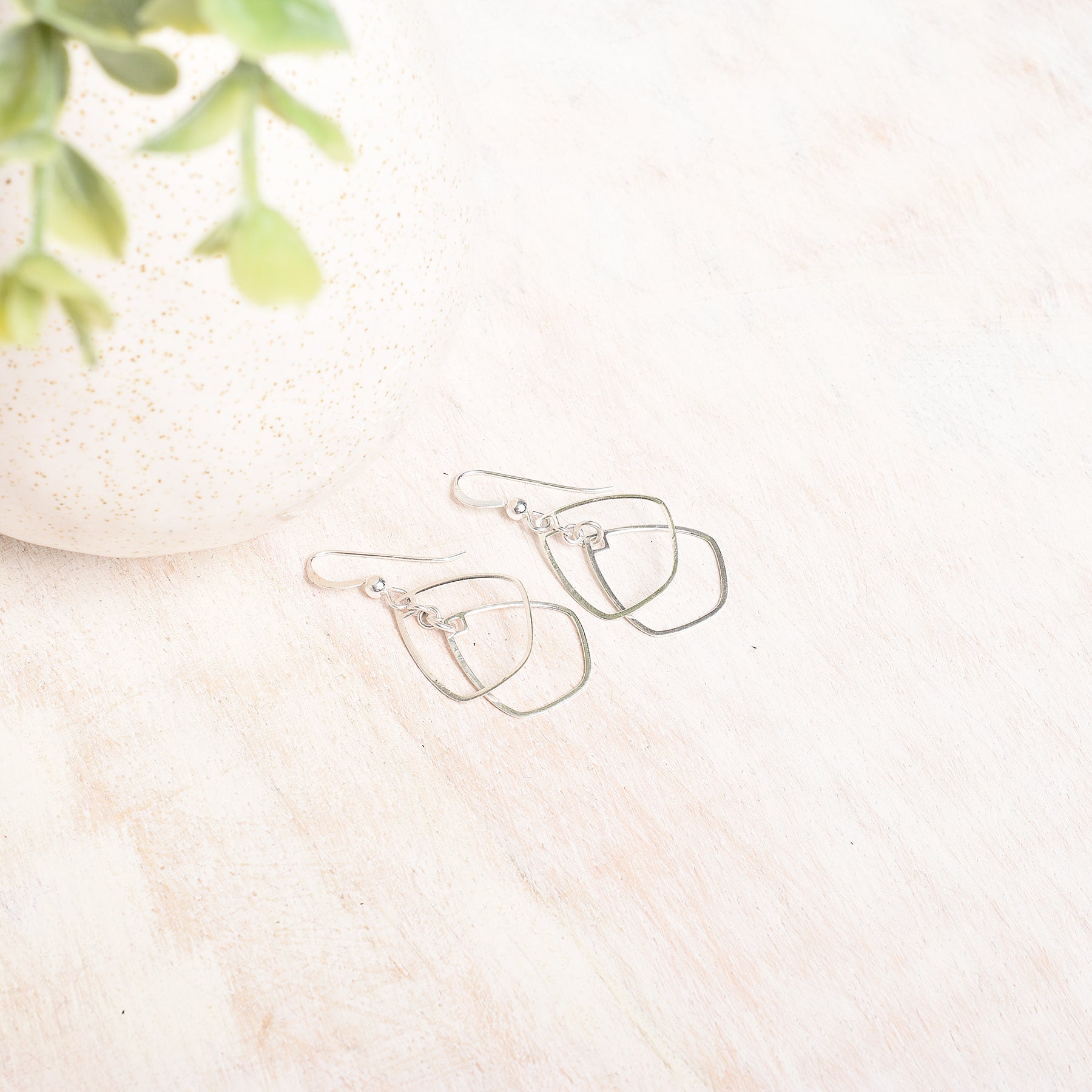 a flatlay photo sterling silver dangly earrings