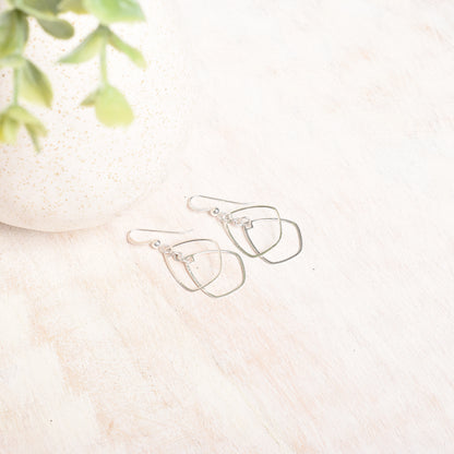 a flatlay photo sterling silver dangly earrings