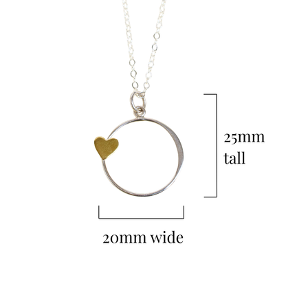 Silver necklace with a bronze heart pendant on a white background