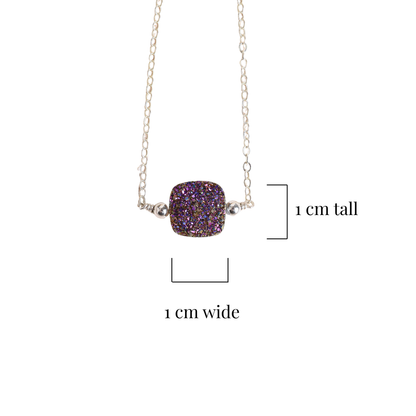 Necklace with a purple druzy pendant on a white background