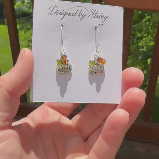 Festive & sparkly pumpkin earrings in the sun