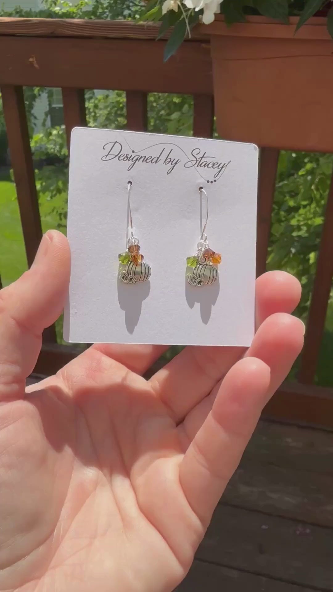 Festive & sparkly pumpkin earrings in the sun